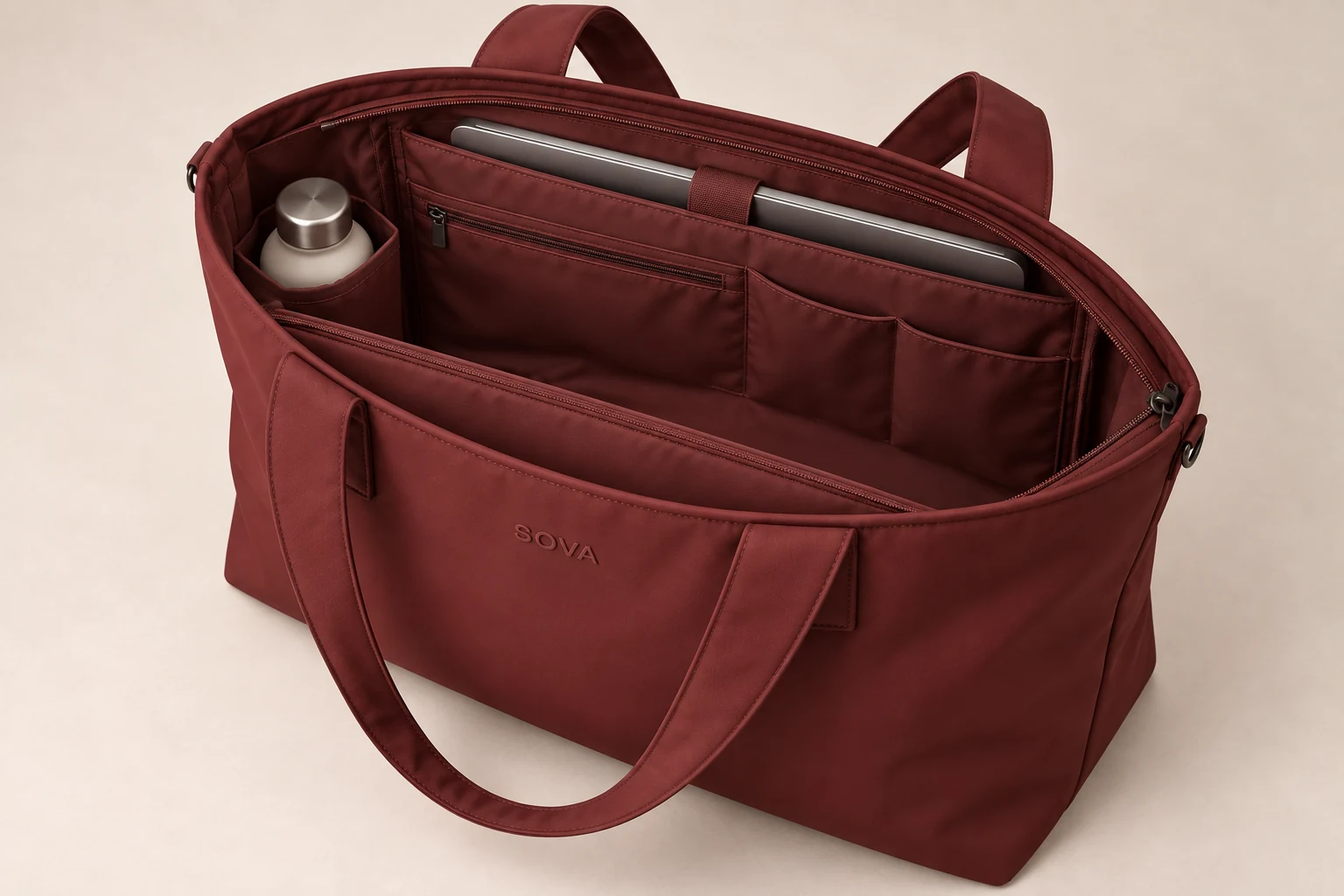 Open SOVA concept tote showing the rear laptop sleeve, bottle pocket and central cavity